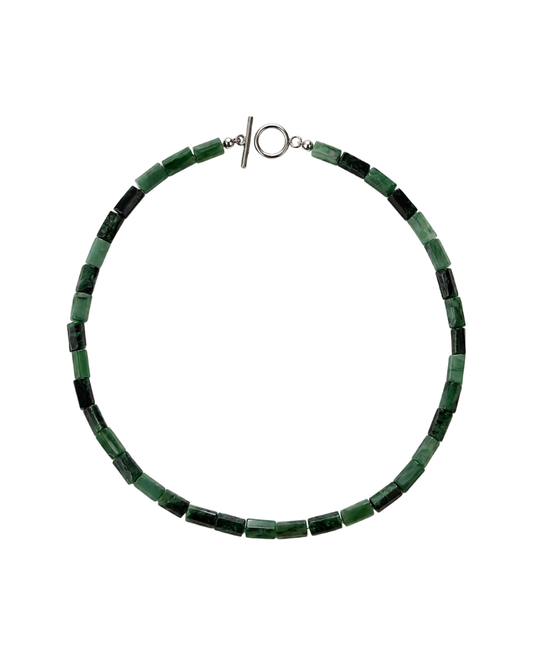 A beaded necklace made of alternating dark green and medium green rectangular beads, featuring a silver toggle clasp, shown on a plain white background.