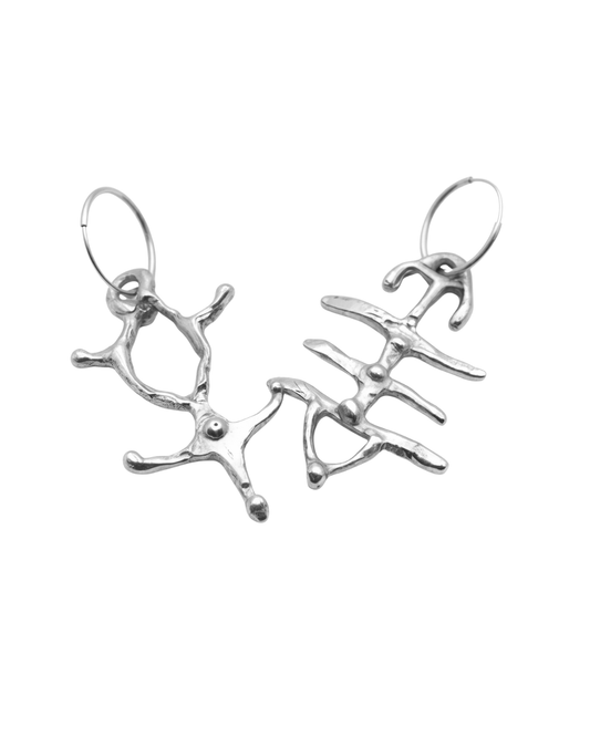 A pair of silver dangling earrings with an abstract, branching organic design and circular hoop backings, shown on a plain white background.