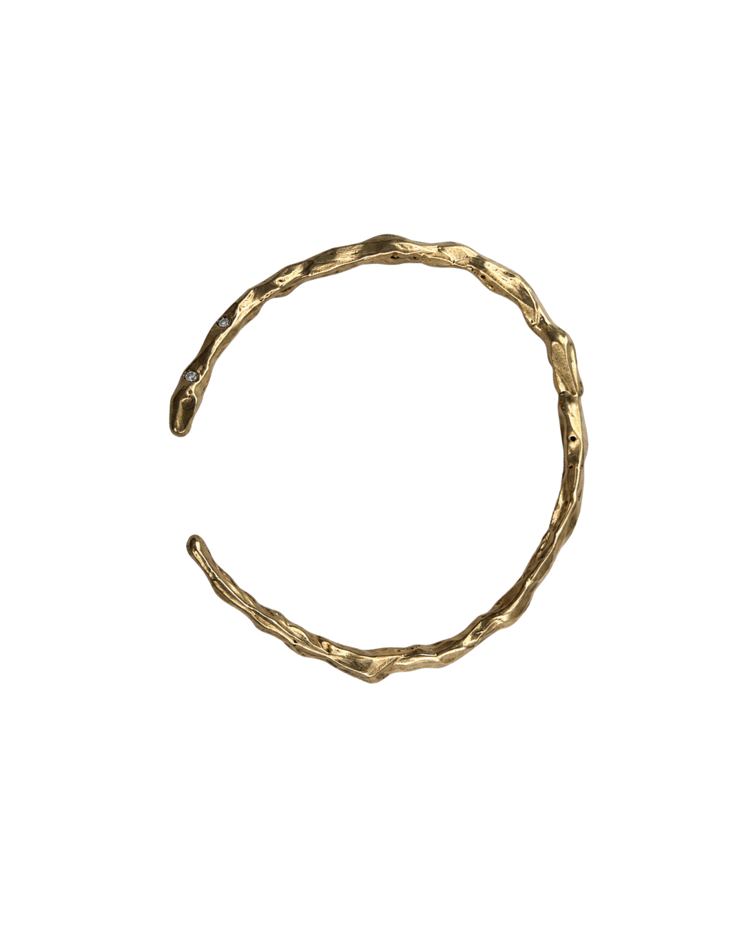 A textured, organic-shaped gold cuff bracelet on a solid white background.