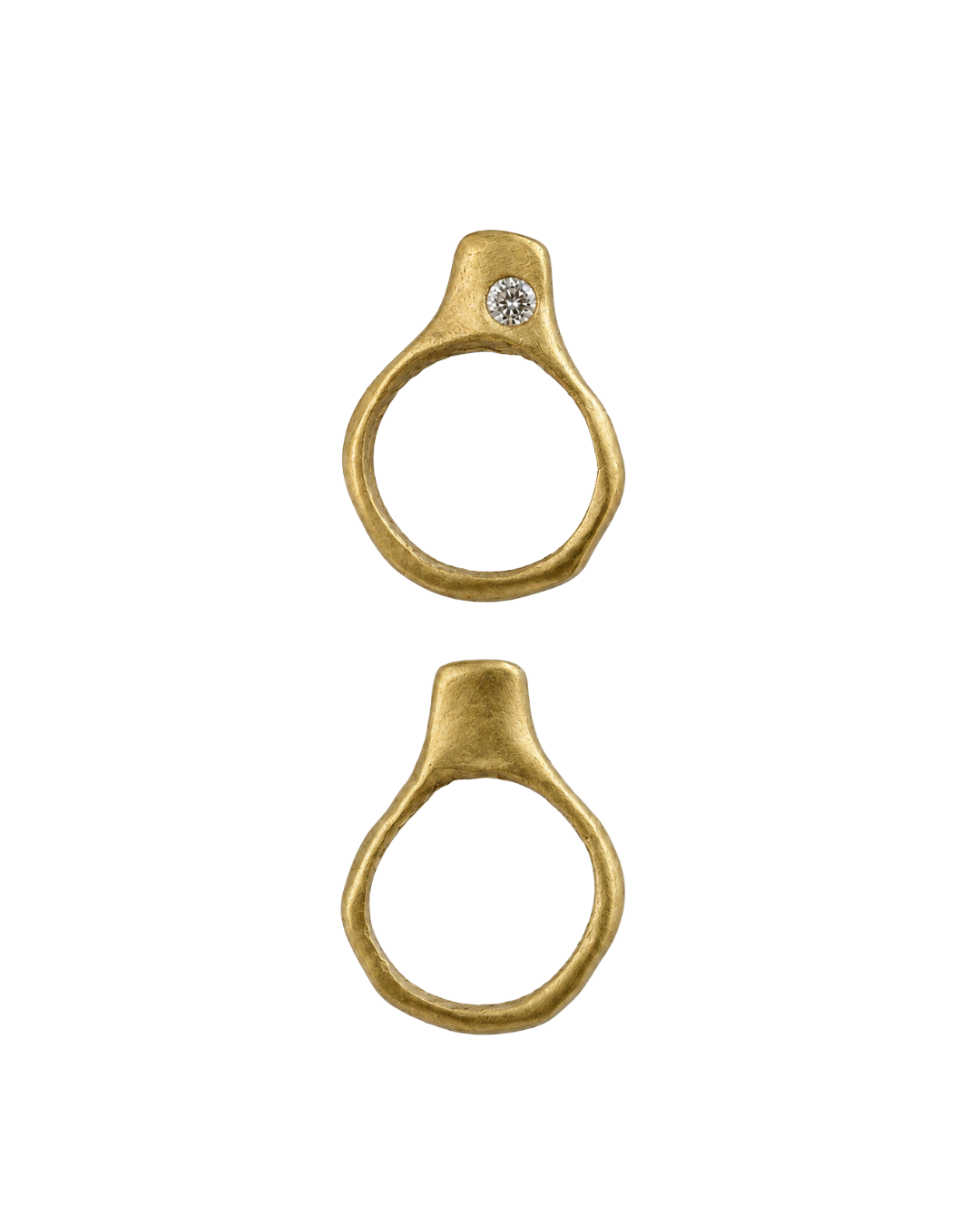 Two gold-toned ring-shaped hardware components with a diamond set in off-center, , shown on a plain white background.