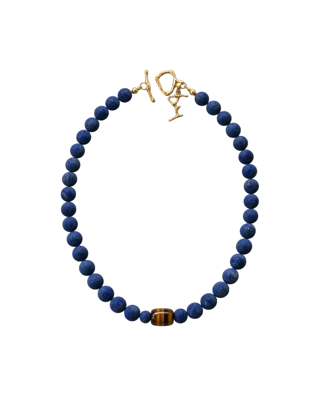 A beaded necklace featuring dark blue lapis lazuli stones and a single brown tiger's eye bead, finished with a gold toggle clasp on a white background.