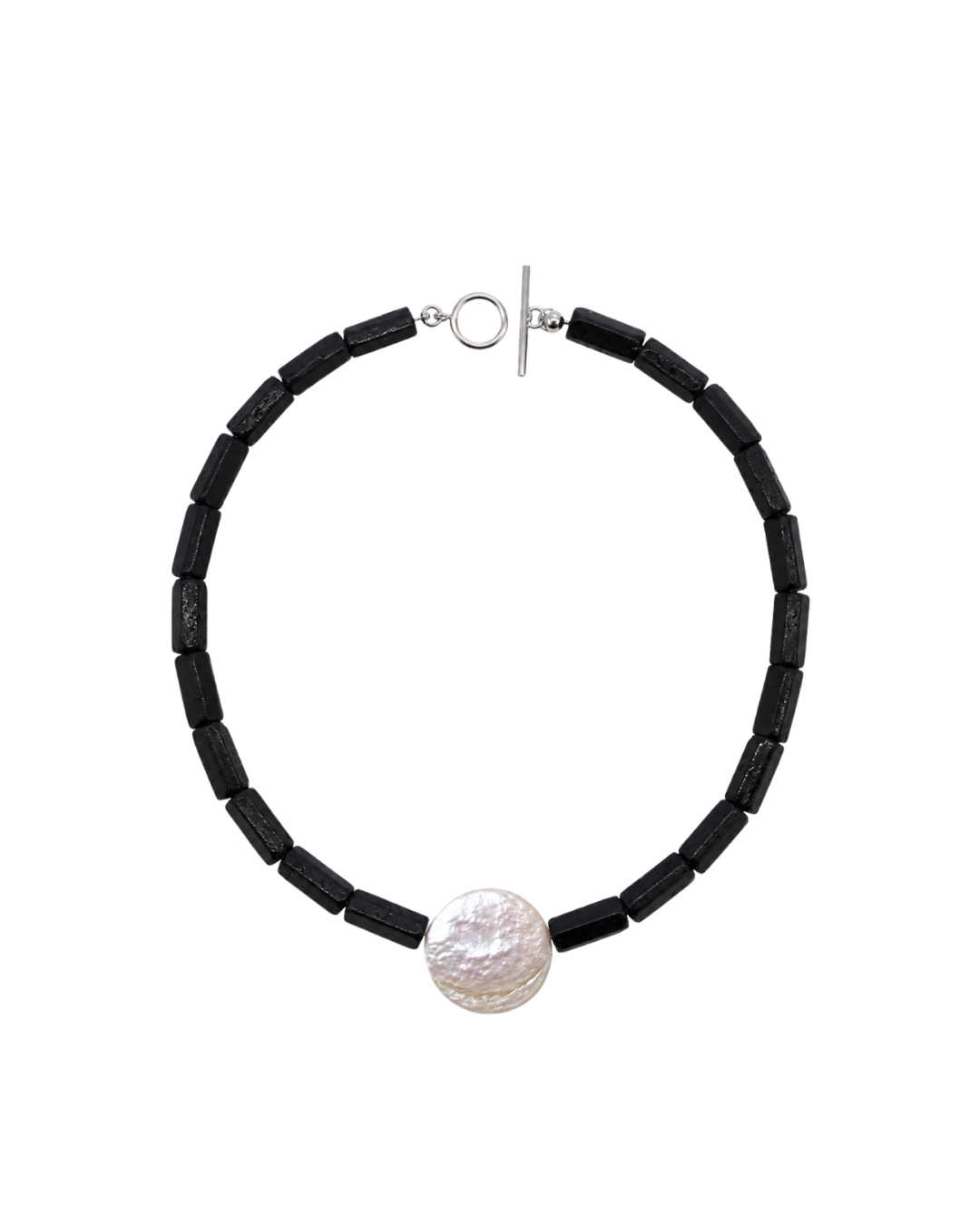 A black tourmaline rough beaded necklace with a textured white pearl pendant and a silver toggle clasp, displayed on a clean white background.